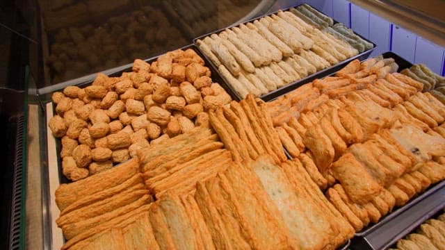 Variety of fish cakes on display at a market stall