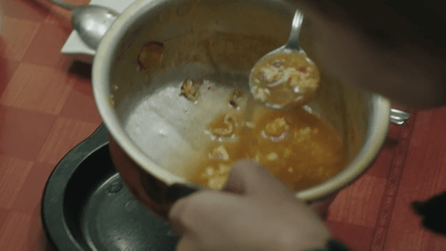 Two people sharing a bowl of ramen at a restaurant