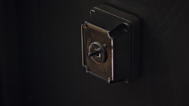 Hand Turning a Vintage Toggle Light Switch On