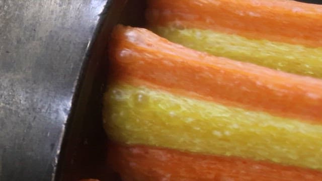 Colorful Jjondeugi Pulled Out of a Factory Machine