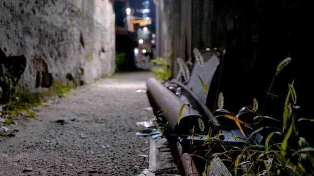 Narrow alley with dim lighting at night