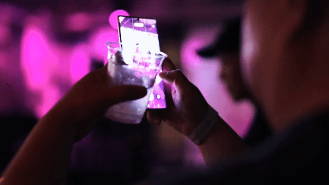 Taking Pictures of a Performance While Enjoying a Drink