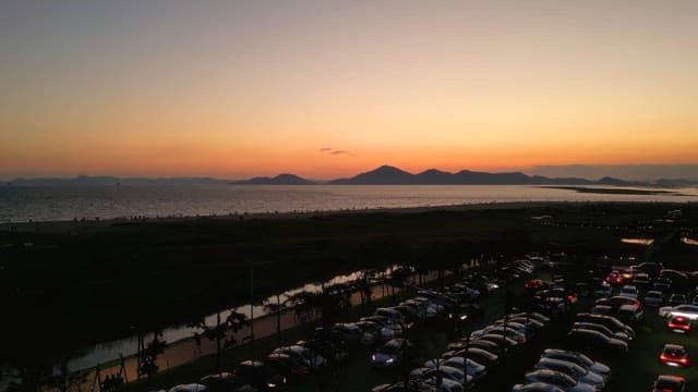 Sunset over a beach with distant mountains