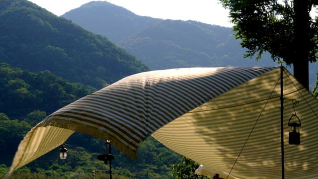 Tent under the mountains during a peaceful afternoon