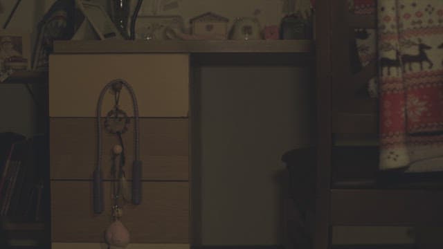 Student entering a dark room and sitting at a desk