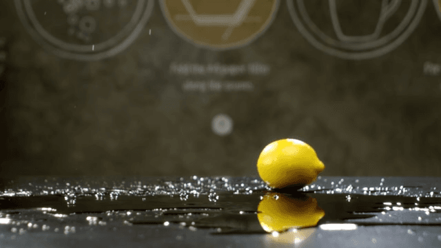 Lemons rolling over a shiny surface