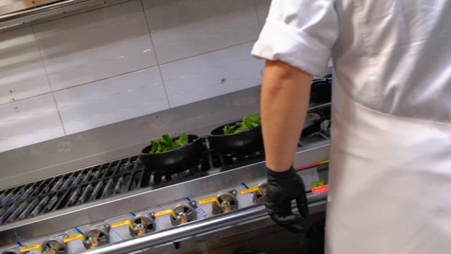 Broth added to soup cooked on a kitchen stove