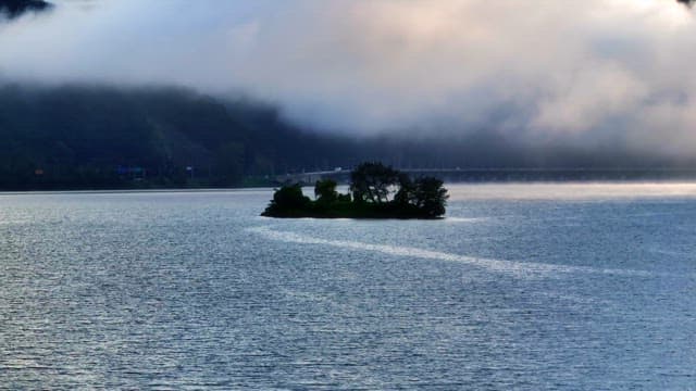 Small island in a misty river
