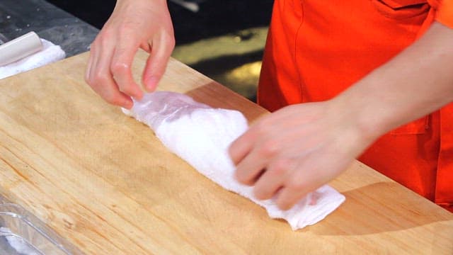 Trimmed flatfish on a wooden cutting board