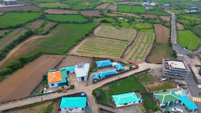 Rural landscape with a few farmhouses and green farmland