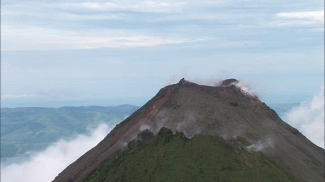 Aerial View of a Misty Vrater of Volcanic Mountain