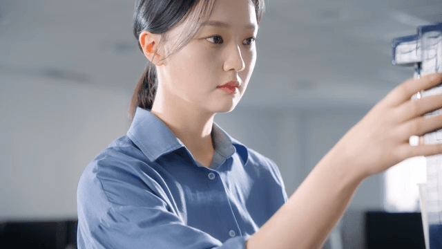 Woman using a coffee machine in an office
