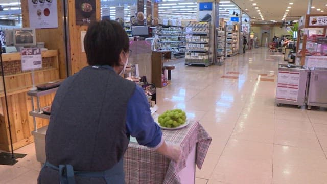 Employee Preparing Samples in Grocery Store