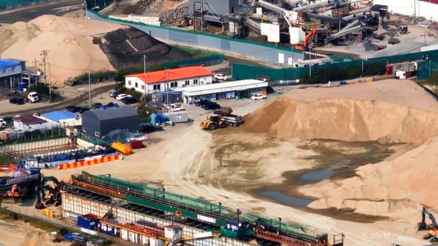 Industrial site with machinery and sand piles