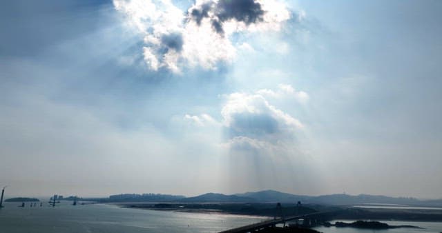 Bridge over a calm sea with sunlight