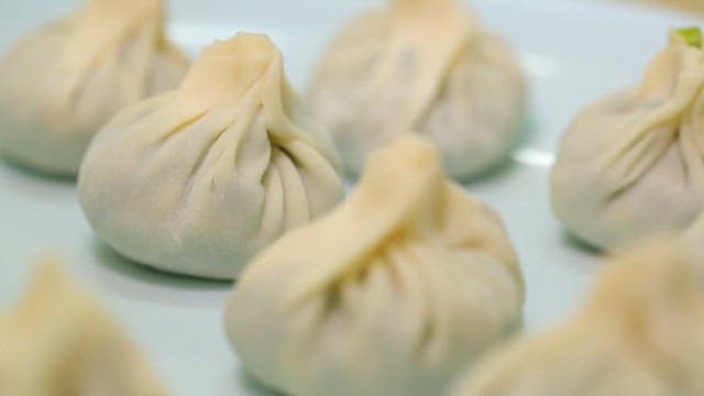 Freshly made dumplings on a white plate