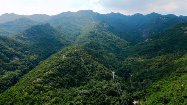 Lush green mountains with cable lines