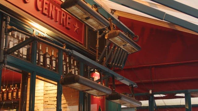 Exterior of the bar, brightly lit at night