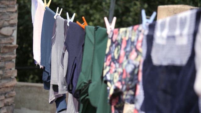 Clothes drying on a line in an urban backyard
