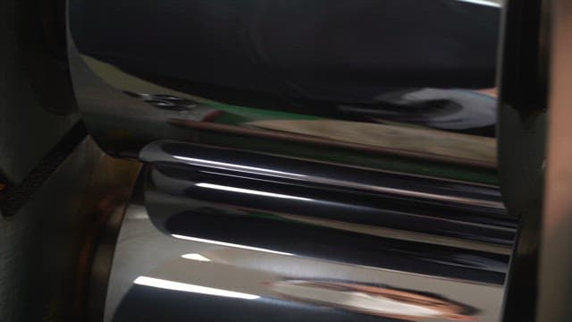 Metallic rollers processing golden foil