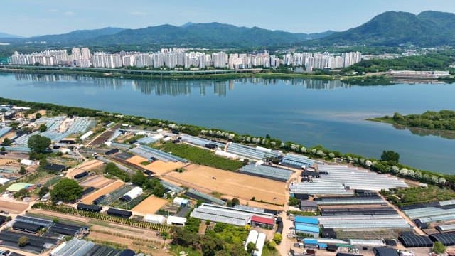 Aerial view of greenhouses and cityscape