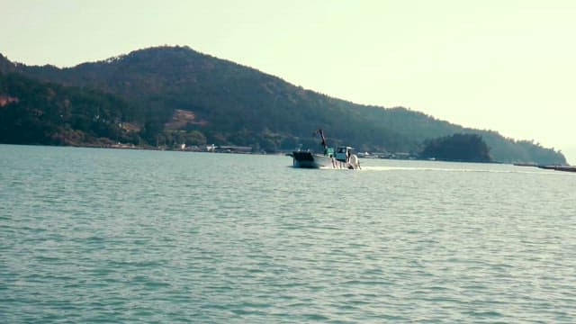 Boat Crossing the Sea near the Beach