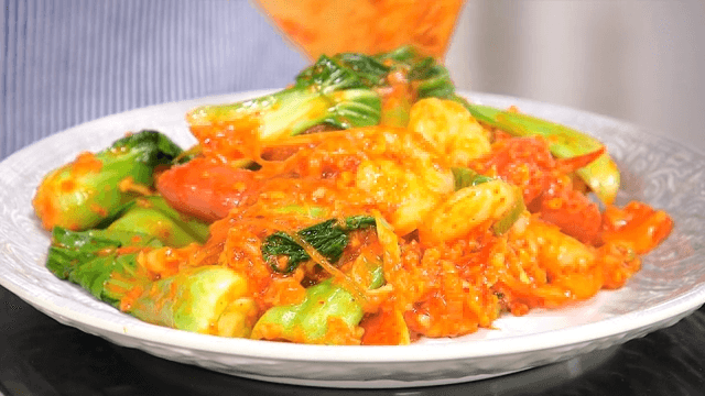 Stir-fried bok choy with red pepper paste served on a plate