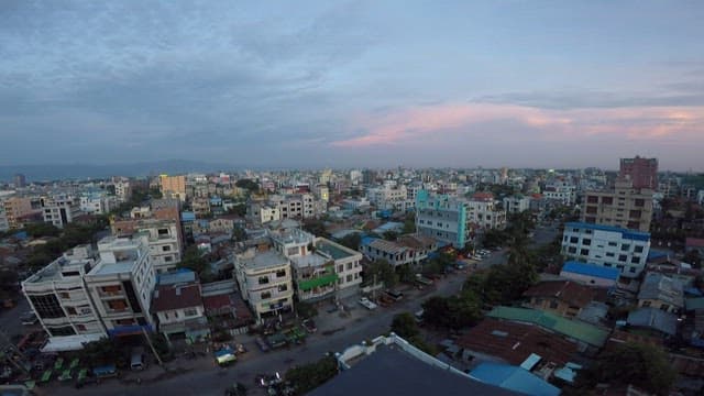 Aerial view of cityscape at dusk transitioning to night