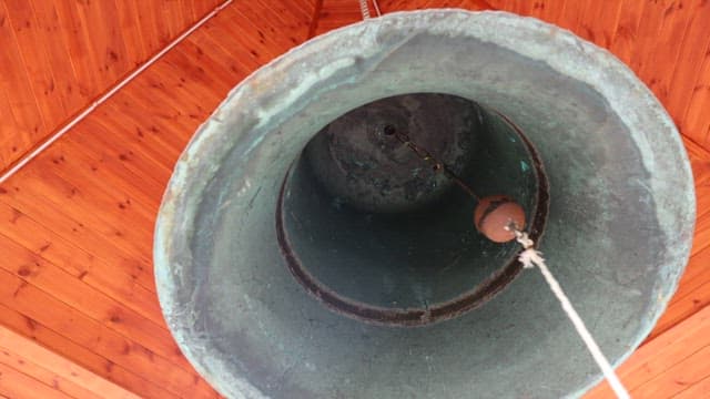 Large church bell with wooden ceiling