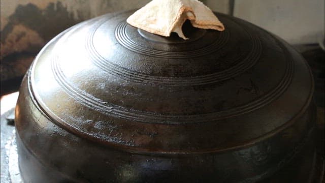 Cooking traditional cuisine in a large pot