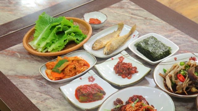 Variety of Korean dishes on a table such as marinated crab and stew