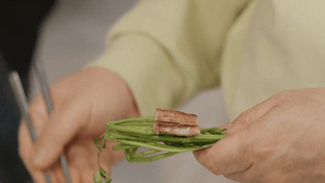 Eating fresh water parsley and pork belly topped with ssamjang