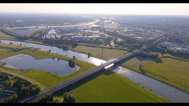 Aerial view of a village with a river and bridge