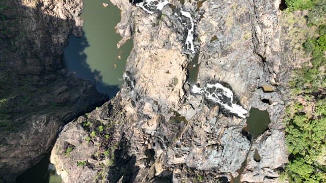 Aerial view of a cascading Barron Falls on a rocky cliff