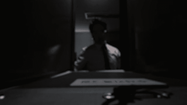 Man Putting Documents in Dark Office Cabinet