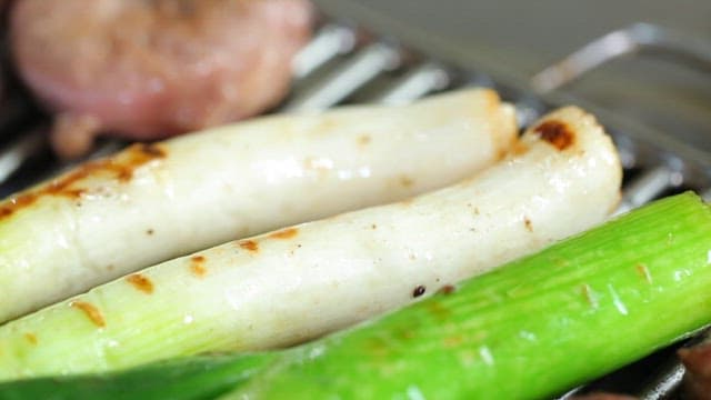 Grilled green onions on a barbecue
