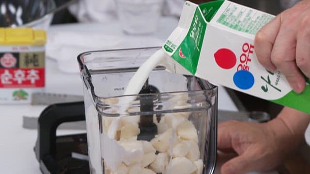Pouring Milk into the Blender with Potatos