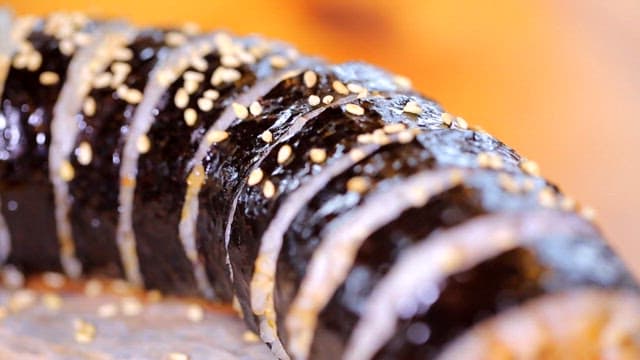 Spicy dombe gimbap sprinkled with sesame seeds