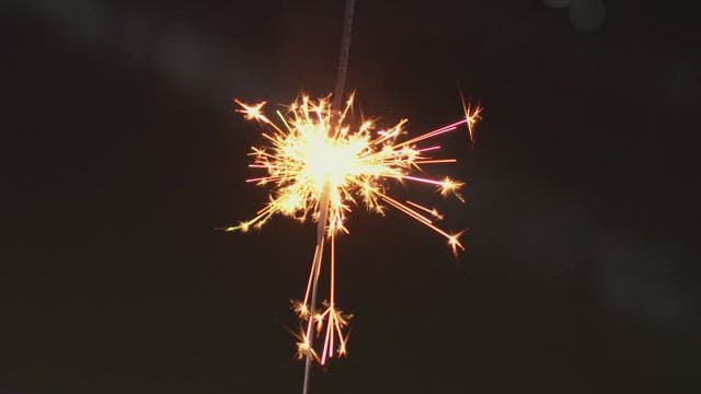 Sparkler burning brightly in the dark night