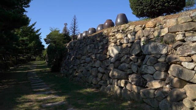 Stone Wall and Jars in Tranquil Garden Path