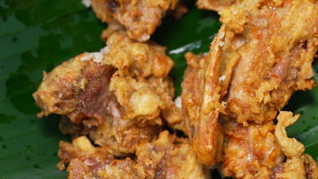 Crispy fried chicken on a banana leaf