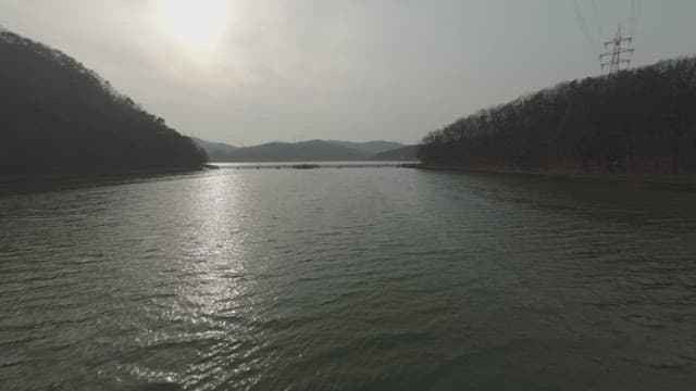 Serene lake with a distant bridge