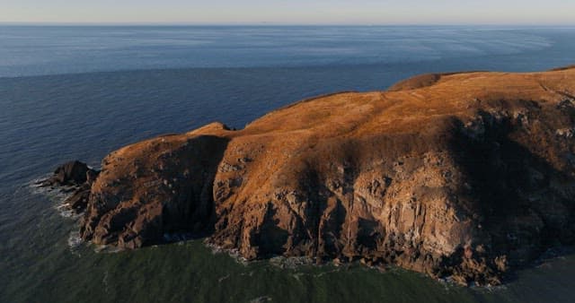Serene Coastal Landscape with Hills and Sea