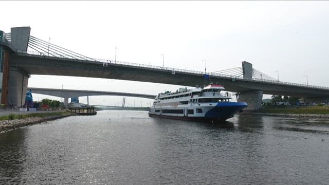 Cruise Ship Sailing Down a Serene River