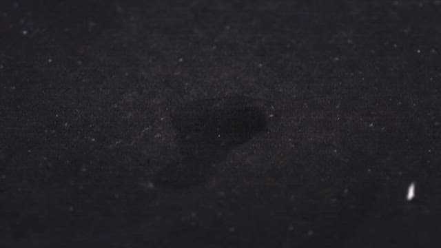 White crystals falling on black floor