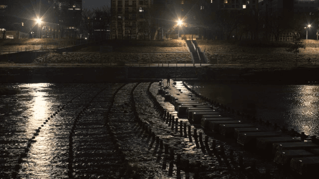 Night view of a city with a river crossing