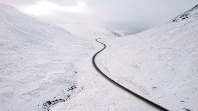 Winding road through snowy mountains