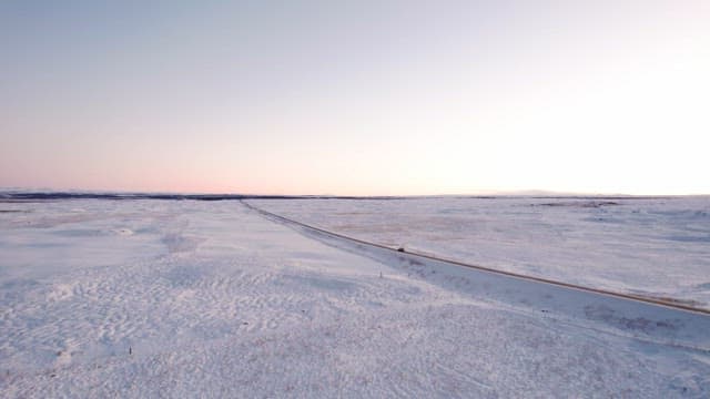 Snowy landscape with a long road