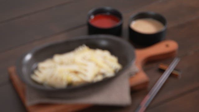 Boiled bamboo shoots, chopsticks, and various sauces on the table