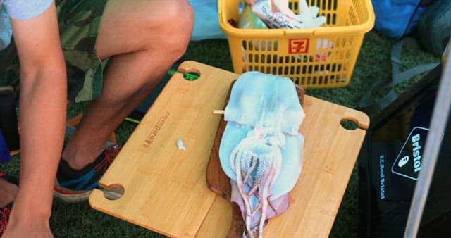Preparing Grilled Squid at an Outdoor Setting